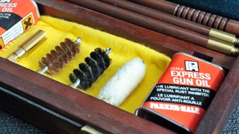 Gun cleaning accessories in a wooden case