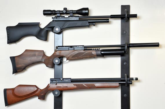 Guns on display in a wall-mounted rack